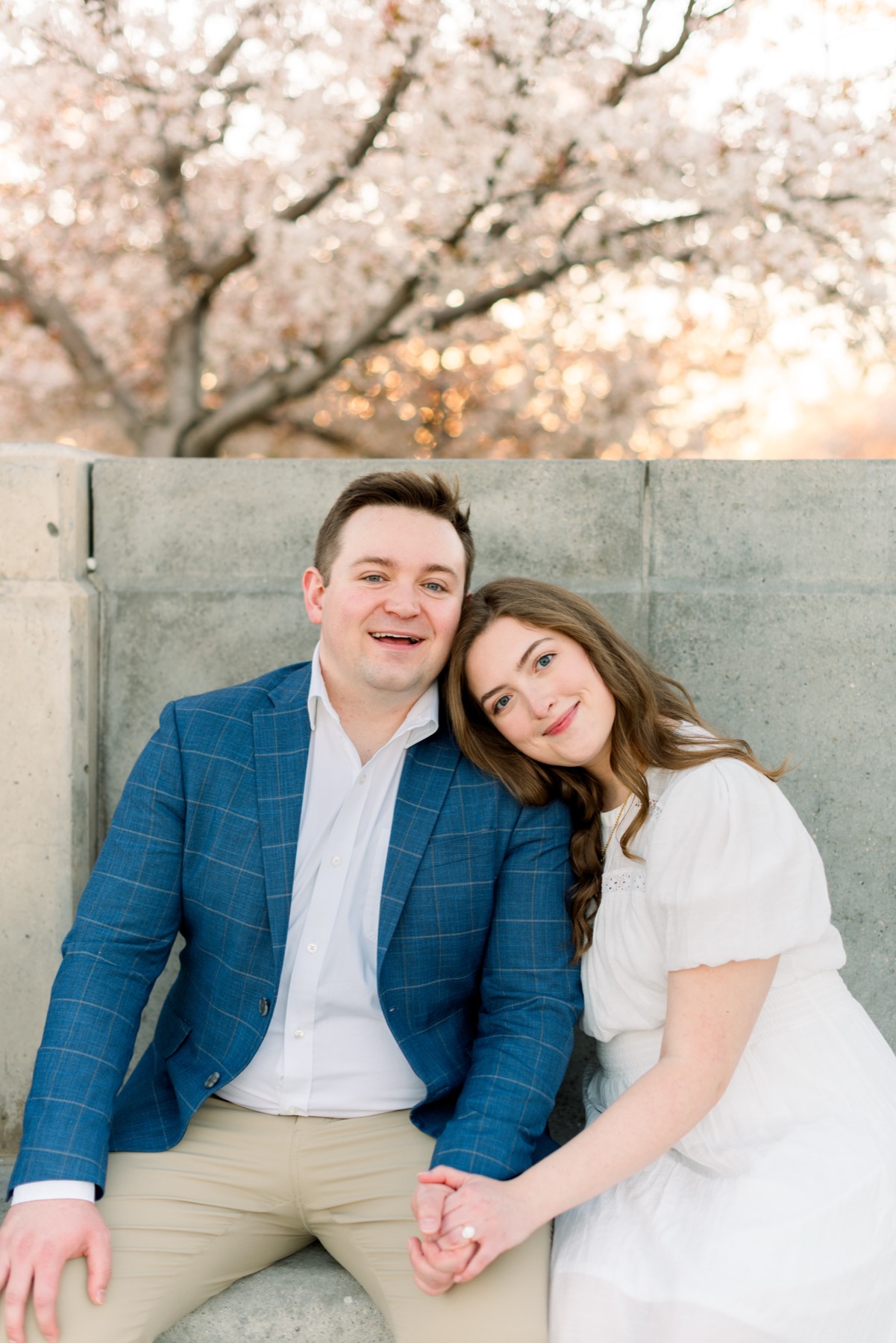 Alex and Bethany sitting together outdoors during their engagement photos
